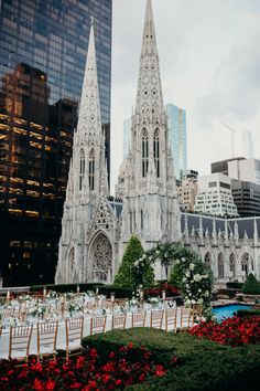 an outdoor wedding set up in front of a cathedral