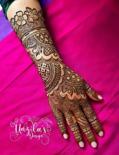 a woman's hand with henna tattoos on it