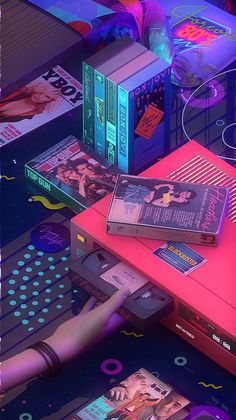 a bunch of books sitting on top of a pink table next to a neon light