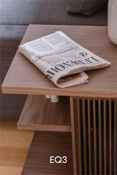 a wooden table topped with a newspaper on top of it