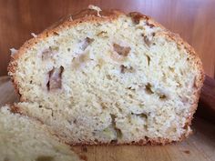 a loaf of bread sitting on top of a cutting board next to an apple slice