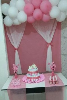 a pink and white dessert table with balloons