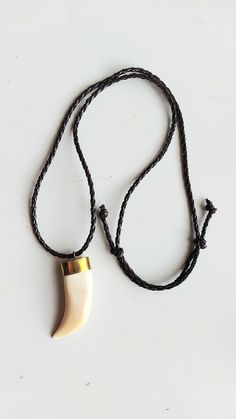 "For discounted prices, please visit our website: https://www.ghanatreasures.com Long braided leather necklace with real camel tooth pendant. Sliding knots closure, max. length 32 inches (80cm.) SHIPPING: please read our shop announcement. Looking for ethnic jewelry supplies on Etsy? Please, check out my shop: https://www.etsy.com/Ghanatreasures All proceeds from the sale of these beads goes to \"The One & Only Cat Sanctuary in Ghana\". Please fan us: https://www.facebook.com/Ghanacatsanctuary" Braided Leather Necklace, Natural Necklace, Tooth Pendant, Sliding Knot Closure, Cat Sanctuary, Nature Necklace, Ethnic Necklaces, Ethnic Jewelry, Braided Leather