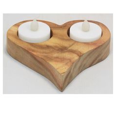 two candles are placed in the shape of a heart