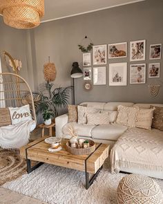 a living room filled with lots of furniture and pictures on the wall above it's coffee table