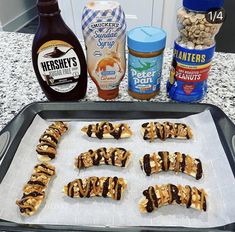 the ingredients to make peanut butter pretzels are laid out on a baking sheet