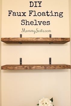 two wooden shelves with flowers on them and the words diy faux floating shelves above