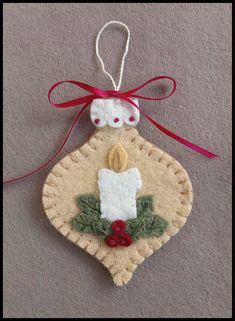 a christmas ornament hanging from a red ribbon