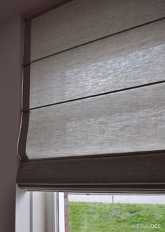 an open window with blinds on the outside