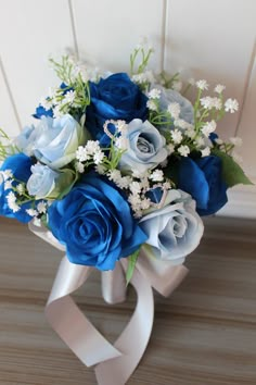 a bouquet of blue roses and white flowers