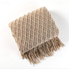 a brown and beige blanket with fringes on it