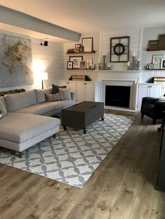 a living room filled with furniture and a fire place under a painting on the wall