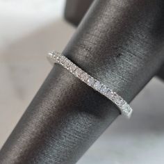 a diamond ring sitting on top of a black cloth