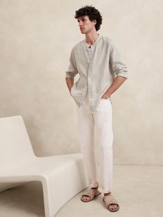 Cut from our signature 100% linen, we love this shirt for its beautiful, natural texture and ability to stay cool and crisp, even in heat and humidity.  Standard fit.  Banded collar and button front.  Shirttail hem.  Standard fit.  Long sleeves.  Hip length.  Model: Size M, 6'2" (188cm). Linen Men Style, Mens Beach Photoshoot Outfit, Linen Outfit Photoshoot, Linen White Shirt Men, Beige Summer Outfit Men, Mexican Guy Outfits, Mens Linen Shirt Outfit, Male Beach Outfit, Linen Men Outfit