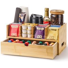 a wooden box filled with lots of different types of coffees and tea bags on top of each other