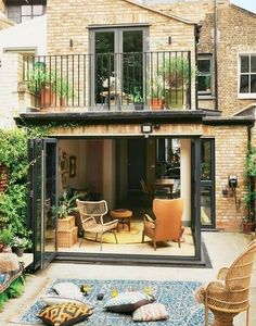 an outdoor living area with patio furniture and potted plants