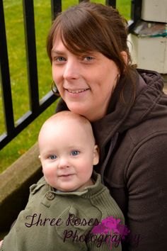 a woman holding a baby in her arms