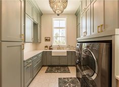 a washer and dryer in a very large room with lots of cupboards