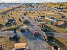 an aerial view of many different types of vehicles parked in a field with trees and grass