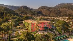 an aerial view of a town with mountains in the background