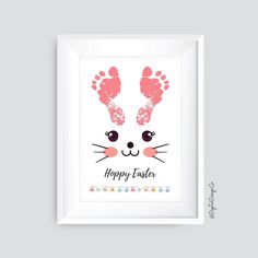 a white frame with a pink bunny's foot prints on it and the words happy easter