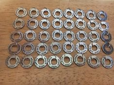 a bunch of metal rings sitting on top of a wooden table