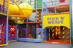 an indoor play area for children with slides and bounce n'weaves on the walls