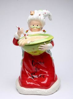 a ceramic figurine of a woman holding a bowl