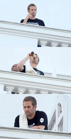 two men are taking pictures on the deck of a ship while another man looks up at them