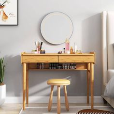 a desk with a mirror and stool in a small room next to a plant on the floor