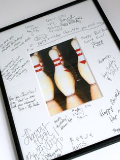 the bowling pins are lined up in a black frame with autographed pictures on them