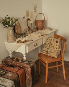 an old fashioned desk with suitcases and baskets on it