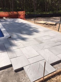 an outdoor patio being built in the middle of a wooded area with concrete blocks laid around it