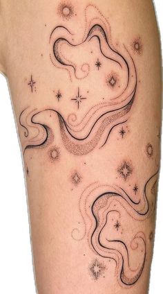 a woman's thigh with stars and swirls on the side, in black ink