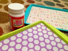 there are two trays with polka dots on them and one has a bottle of glue