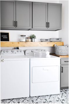 a white washer and dryer sitting next to each other in a laundry room