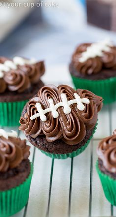 cupcakes with chocolate frosting and football decorations