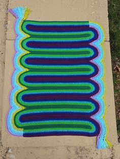 there is a crocheted blanket on the sidewalk