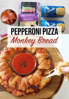 pepperoni pizza monkey bread on a wooden platter with dipping sauce in the middle