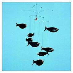 a group of fish that are hanging from a string in the air with a fishing hook