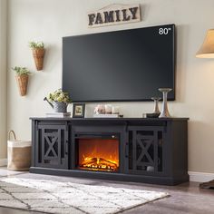 a living room with a fireplace and television on the wall in front of an entertainment center