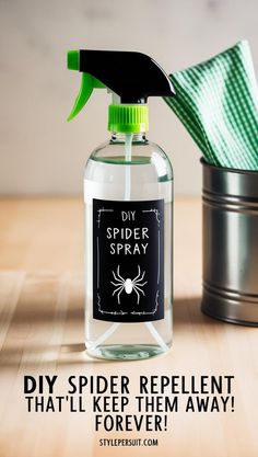 a spider repellent bottle sitting on top of a wooden table