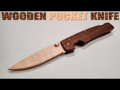 a wooden pocket knife sitting on top of a white surface with the words wooden pocket knife above it