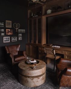 a living room filled with furniture and a flat screen tv mounted to the side of a wall