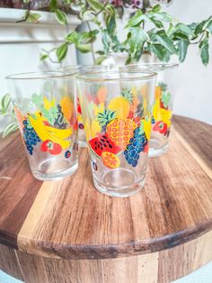 three glasses sitting on top of a wooden table