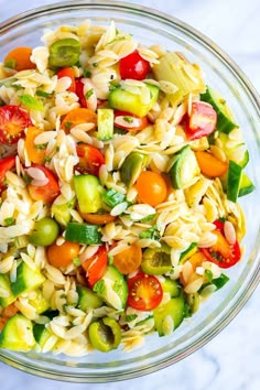 a bowl filled with pasta salad on top of a table