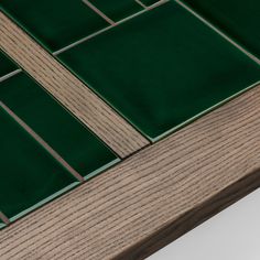 a wooden table with green tiles on it