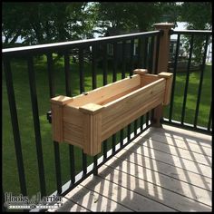 a wooden planter sitting on top of a metal rail