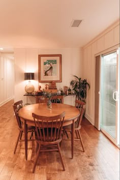 a wooden table and chairs in a room