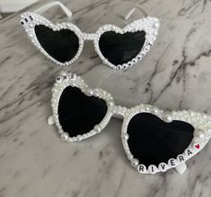 These custom made personalized sunglasses are perfect for a Bachelorette Weekend, Bridal Shower, or Wedding Weekend. They are made to order with your NEW last name or saying that you like! These are the perfect gift for you BFF or treat your self ;) Can be customized with any name/ saying!  Each pearl is hand placed. These sunglasses will be shipped in bubble for protection and should be handled with care. These sunglasses do take a bit more time but should ship within a week of ordering! If you need them sooner- please let us know and we will give you current availability  Heart sunglasses measure approx. 15 x 6.8 x 6.3 cm/ 5.91 x 2.68 x 2.48 inches, with the bridge of approx. 1.3 cm/ 0.51 inches in length and the legs of the sunglasses measuring about 14 cm/ 5.51 inches, which are suitab Customizable White Adjustable Sunglasses, Bridesmaid Sunglasses, Bridal Sunglasses, Bling Sunglasses, Personalized Sunglasses, Bach Party, Heart Sunglasses, Bachelorette Weekend, Venue Ideas